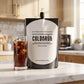 COLDBRUH Signature Dark Roast cold brew 18oz pouch with a glass of iced coffee on a kitchen counter