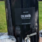 COLDBRUH glass cold brew dispenser with a branded cup, served outdoors