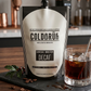 COLDBRUH Swiss Water Decaf cold brew pouch next to a glass of iced coffee